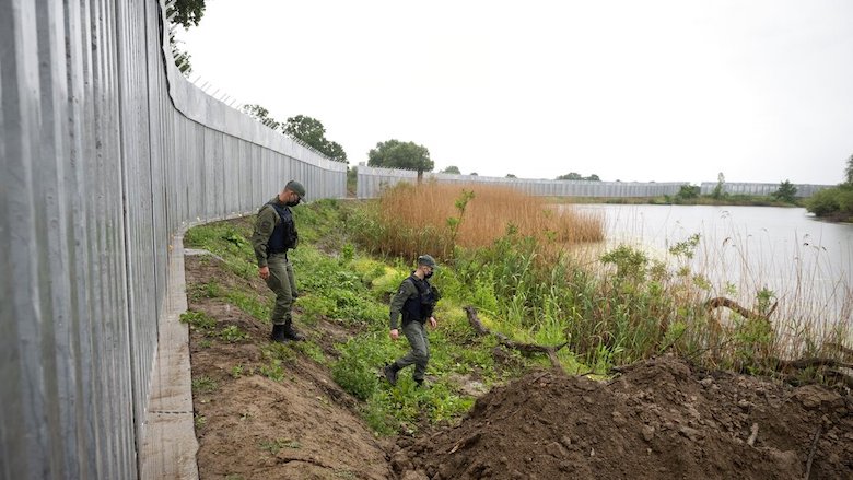 Police patrol alongside a steel wall at Evros river, near the village of Poros, at the Greek-Turkish border, Greece, May 21, 2021. (Photo: Giannis Papanikos/AP)