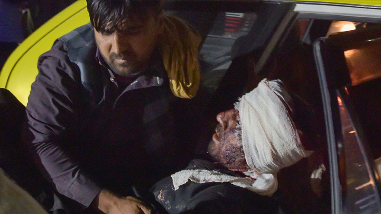 Medical and hospital staff carry an injured man out of a car for treatment after two blasts, which killed at least five and wounded a dozen, outside the airport in Kabul, August 26, 2021. (Photo: Wakil Kohsar/AFP)
