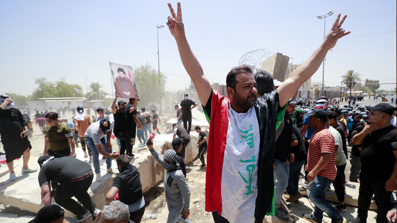 Supporters of the Iraqi cleric Moqtada Sadr celebrate after bringing down concrete barriers leading to the capital Baghdad's Green Zone, July 30, 2022. (Photo: Ahmad Al-Rubaye/AFP)