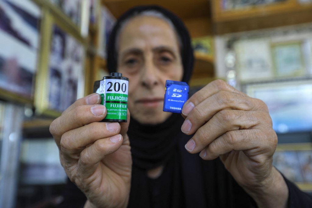 Iraqi photographer Samira Mazaal shows an analog film roll and a memory card during an interview at her studio in the city of Amarah in Iraq's southeastern Maysan province , July 9, 2022. (Photo: Asaad Niazi/AFP)
