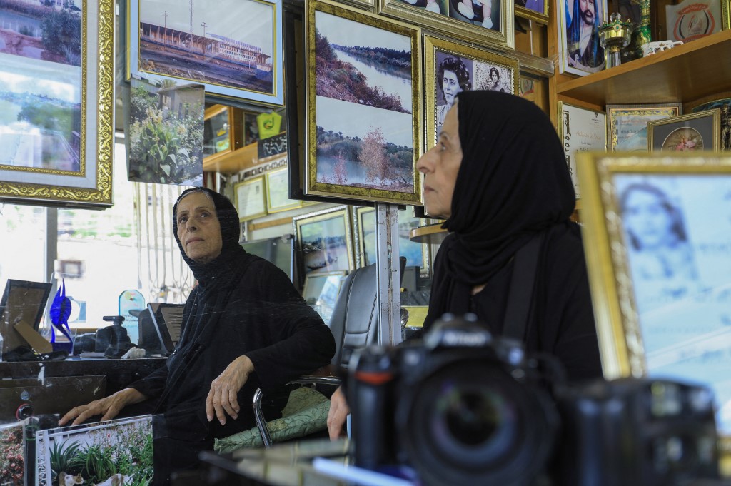 Iraqi photographer Samira Mazaal looks at framed images during an interview at her studio in the city of Amarah in Iraq's southeastern Maysan province , July 9, 2022. (Photo: Asaad Niazi/AFP)