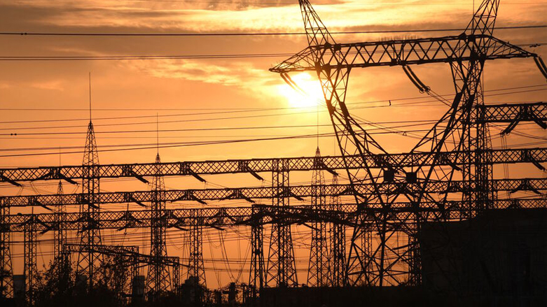 The sun sets behind electrical grids in the southern Iraqi city of Nasiriyah in Dhi-Qar province, Jan. 3, 2021. (Photo: Asaad Niazi/AFP)