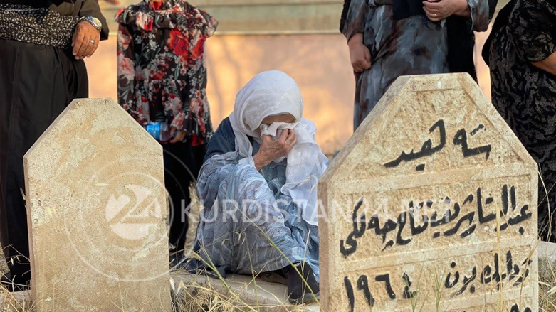 A woman crying on grave of one of the victims of Anfal, Kurema village, Duhok in Duhok province, August 28, 2022. (Photo: Kurmanj Nhili/Kurdistan 24)
