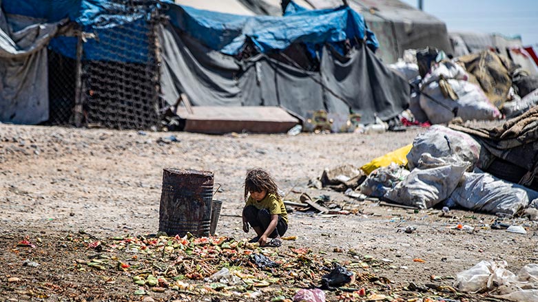 A girl sifts through garbage at the Sahlat al-Banat makeshift camp for internally displaced people, July 10, 2023. (Photo: Delil Souleiman/ AFP)