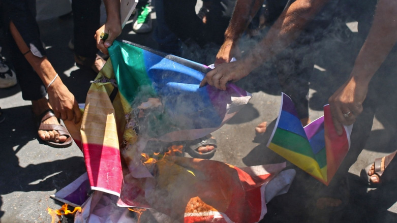Angry Iraqis burn LGBTQ+ and Swedish flags in June (Photo: Hussein Faleh/AFP)