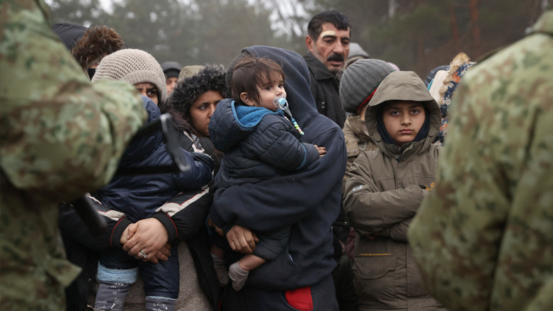 A group of Iraqi migrants stands in a camp near the Belarusian-Polish border in the Grodno region, Nov. 14, 2021. (Photo: Oksana Manchuk/Belta/AFP)