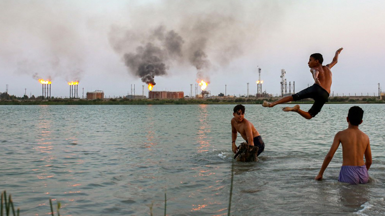 Iraqi youths swim in the Shatt al-Arab waterway at the end of a hot summer day in the southern Iraqi city of Basra, Aug. 11, 2023. (Photo: Hussein Faleh/AFP)