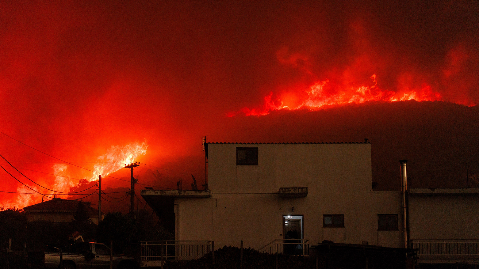 A wildfire burns a forest near a house in Avantas village, near Alexandroupolis town, in the northeastern Evros region, Greece, Aug. 21, 2023. (Photo: Achilleas Chiras/ AP)