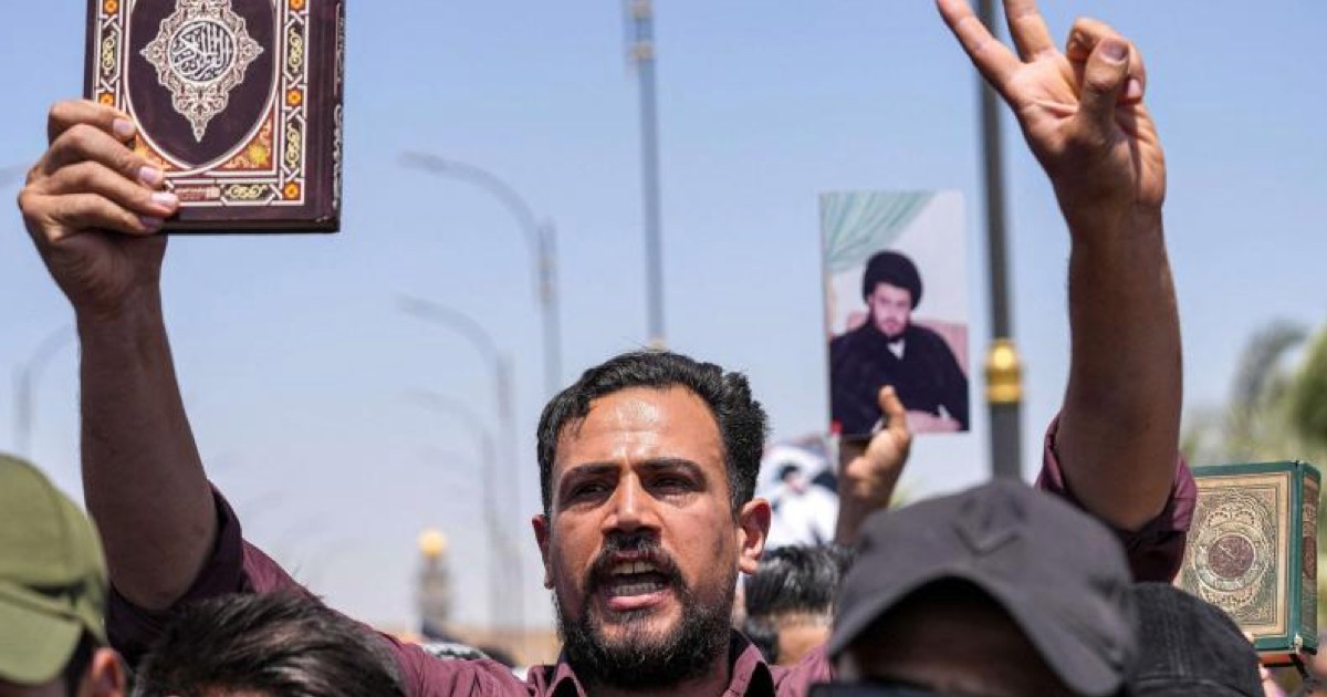 A supporter of Iraqi Shia cleric Moqtada al-Sadr holds up a copy of the Quran during a rally in Iraq’s city of Kufa denouncing the burning of the Muslim holy book in Sweden (Photo: AFP)