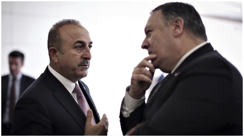 Turkish Foreign Minister Mevlut Cavusoglu (left) talks