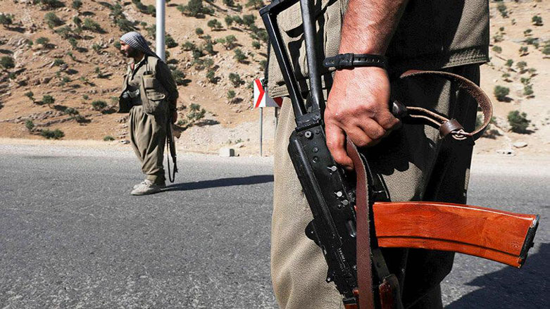 Two PKK militants stand at a checkpoint. (Photo: AFP/Safin Hamed)