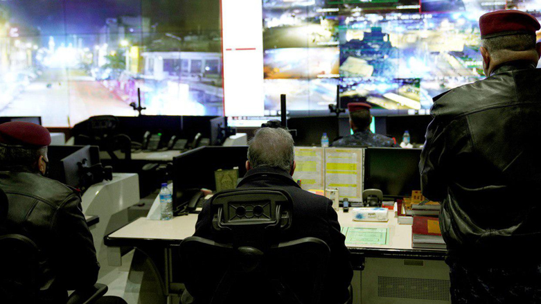 Iraqi Mustafa a;-Kadhimi watches surveillance footage of Baghdad. (Photo: PM Media Office)