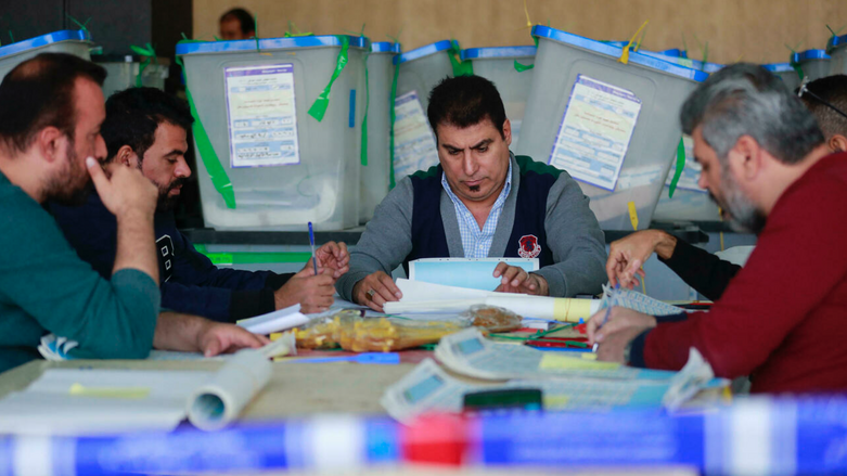 Employees of Iraq's Independent High Electoral Commission conduct a partial manual recount of votes for the October 10 parliamentary elections, in Baghdad, Nov. 23, 2021. (Photo: Ahmad Al-Rubaye/AFP)