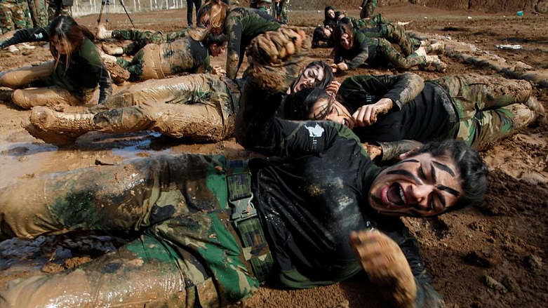 Female Peshmerga officers roll through mud during their graduation ceremony at a military camp in the town of Soran in Iraq's Kurdistan Region, February 12, 2020. (Photo: AFP)