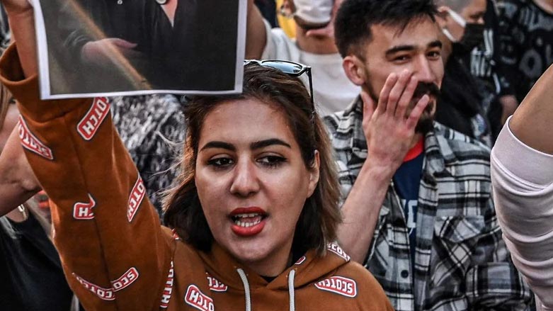 A protester holds a portrait of Mahsa Amini during a demonstration in support of Mahsa Amini. (Photo: AFP)