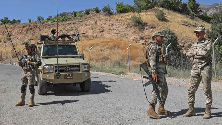 Iraqi border forces stand guard outside a mountain tourist spot which was hit with artillery bombardment in the Zakho district village of Parakh in the north of Iraq's autonomous Kurdish region, July 22, 2022. (Photo: Safin Hamed/AFP)