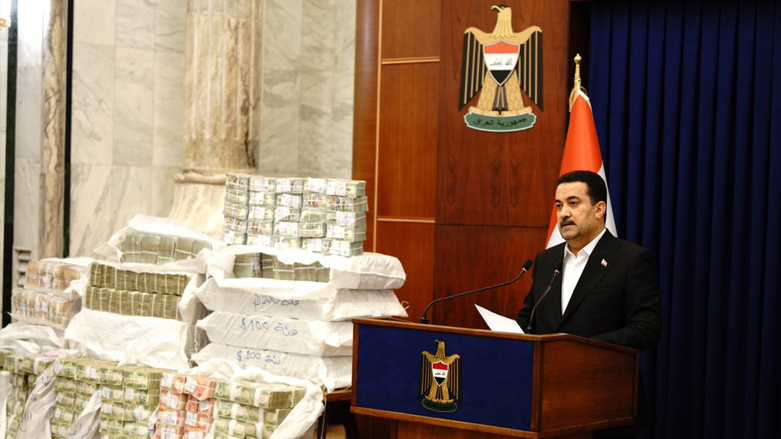 Iraqi Prime Minister Mohammad Shia' Al-Sudani speaks during a presser against the backdrop of sacks of the recovered stolen money from the tax authority in Baghdad, Nov. 27, 2022. (Photo: Iraqi Prime Minister Office)
