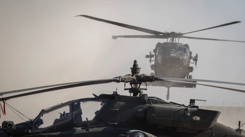 A Black Hawk helicopter lands next to an Apache attack helicopter at a U.S. military base at undisclosed location in Eastern Syria, Monday, Nov. 11, 2019 (Photo: AP)