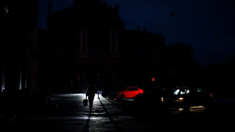 A pedestrian walks down a street during a power cut in downtown Odesa on December 5, 2022, amid the Russian invasion of Ukraine (Photo: Oleksandr Gimanov | AFP | Getty Images)