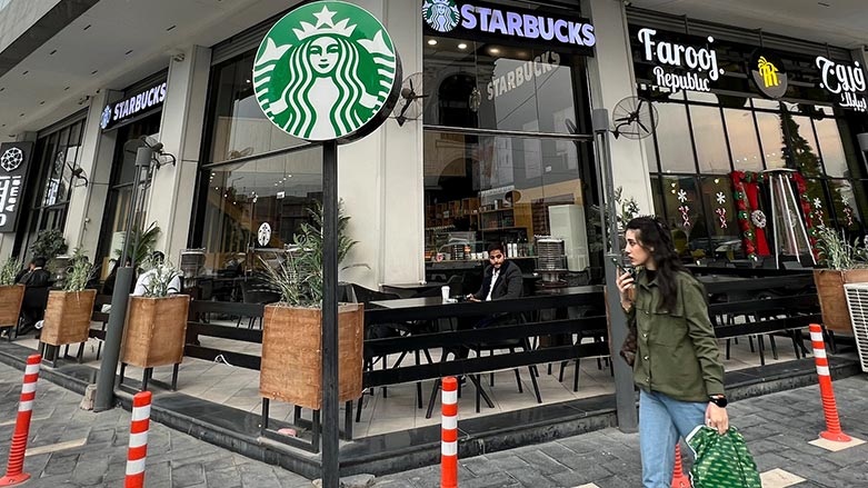 A woman walks by an unlicensed Starbucks cafe in Baghdad, Iraq, Wednesday, Dec. 21, 2022. (Photo: Ali Abdul Hassan/AP)