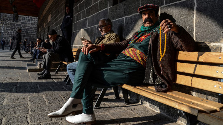 A man in traditional outfits sits on a bench in the courtyard of Ulu Mosque in Diyarbakir, Dec. 23, 2022. (Photo: Ilyas Akengin/AFP)
