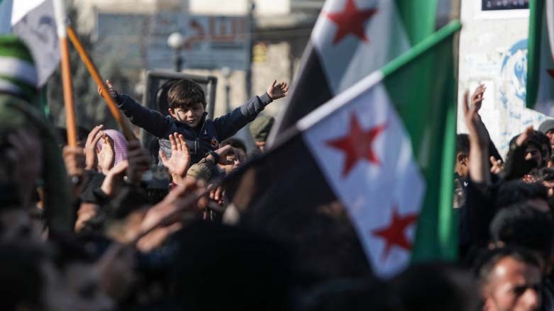Demonstrators raise Syrian opposition flags and placards as they rally against a potential rapprochement between Ankara and the Syrian regime, on December 30, 2022 (Photo: Bakr ALKASEM/AFP)