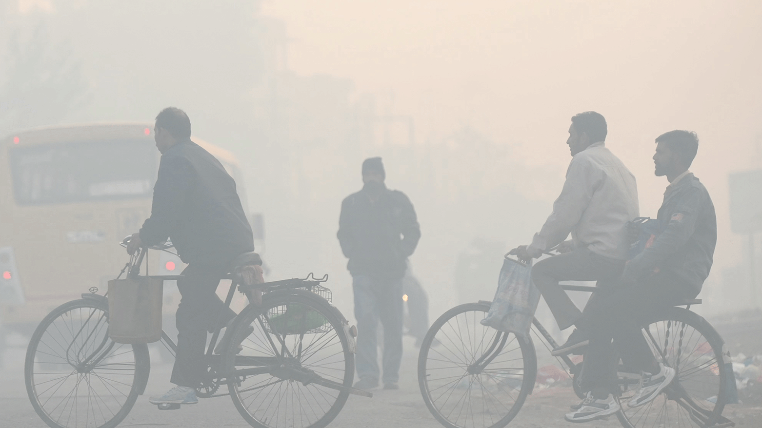 Men ride bicycles along a street, amid dense smog in the outskirts of Amritsar, India on December 5, 2023. (Photo: AFP)