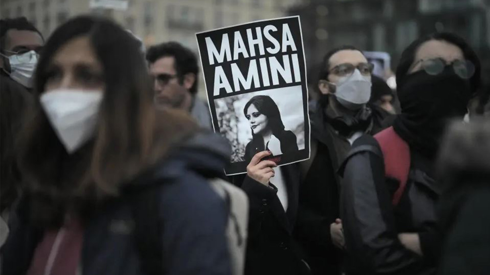 A woman shows a placard with a photo of of Iranian Mahsa Amini as she attends a protest against her death, in Berlin, Sept. 28, 2022. (Photo: AP)