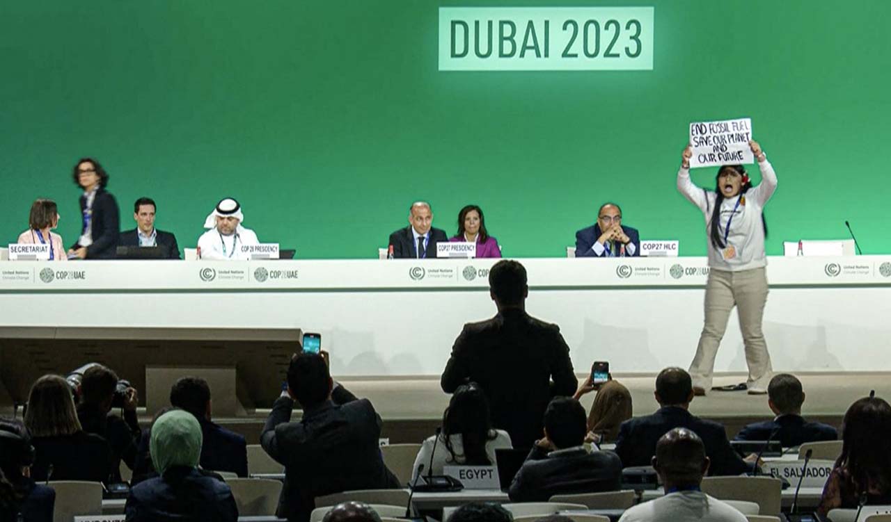activist protesting on stage against fossil fuels during an event at the United Nations Climate Conference (COP28) in Dubai, Dec. 11, 2023. (Photo: AFPTV)
