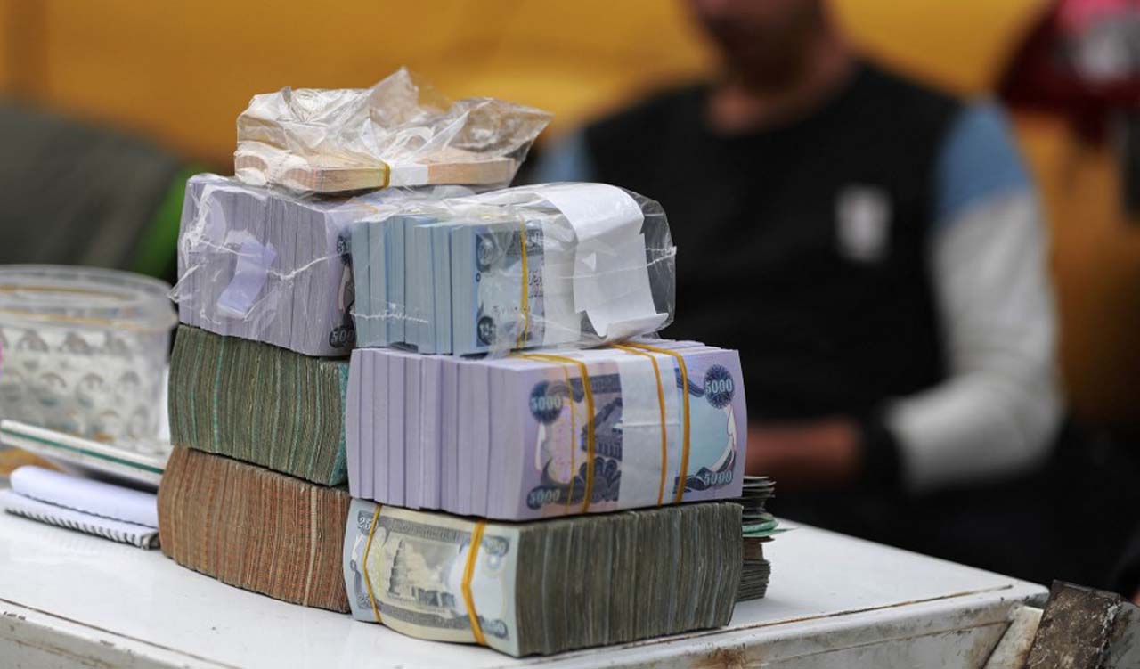 A currency exchange agent counts US Dollars at his company in Baghdad, Dec. 12, 2023. (Photo: Ahmad Al-Rubaye/AFP)