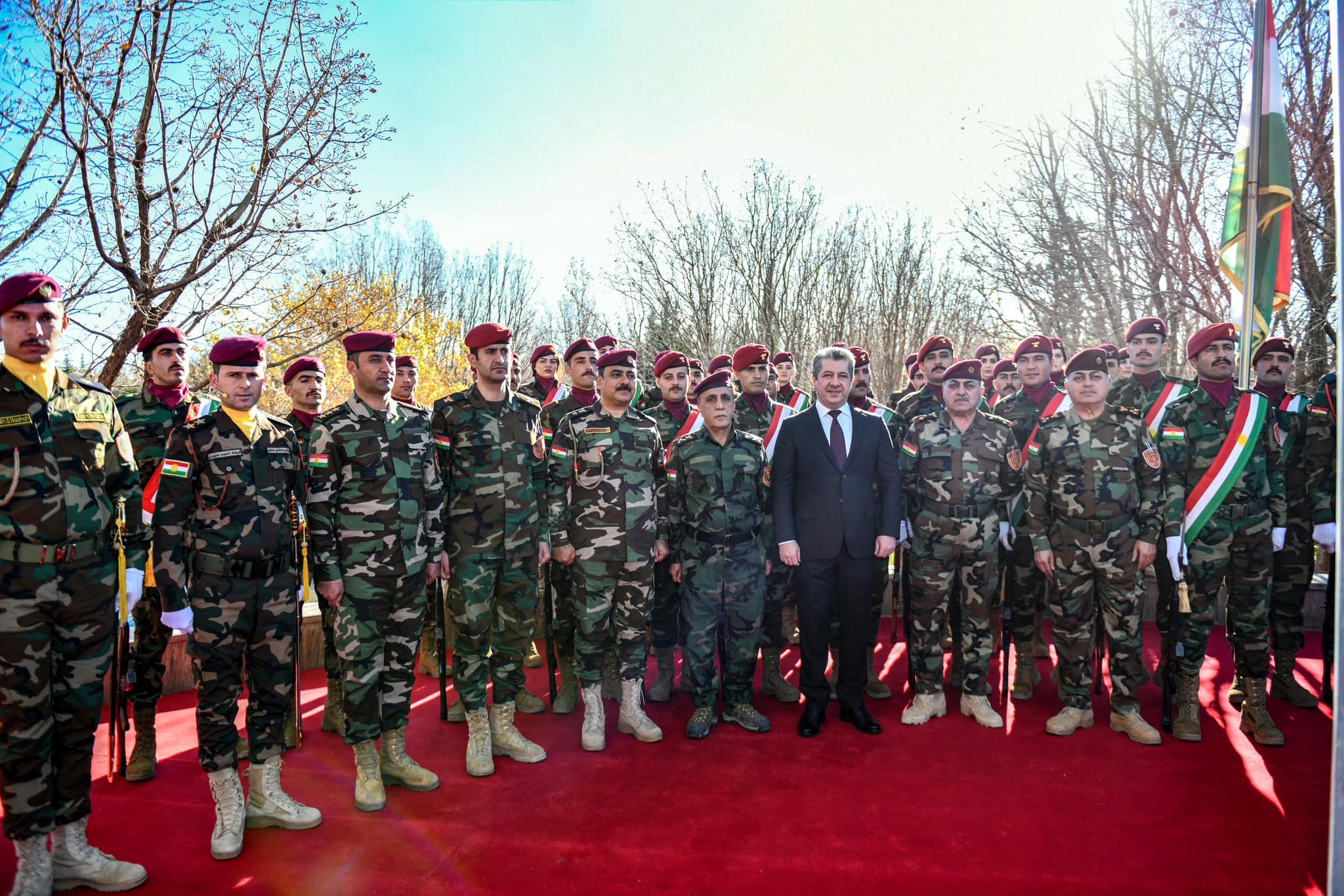 Kurdistan Region Prime Minister Masrour Barzani (sixth from right) standing for a group photo with members of Peshmerga forces in Erbil to mark Kurdistan Flag Day, Dec. 17, 2023. (Photo: KRG)