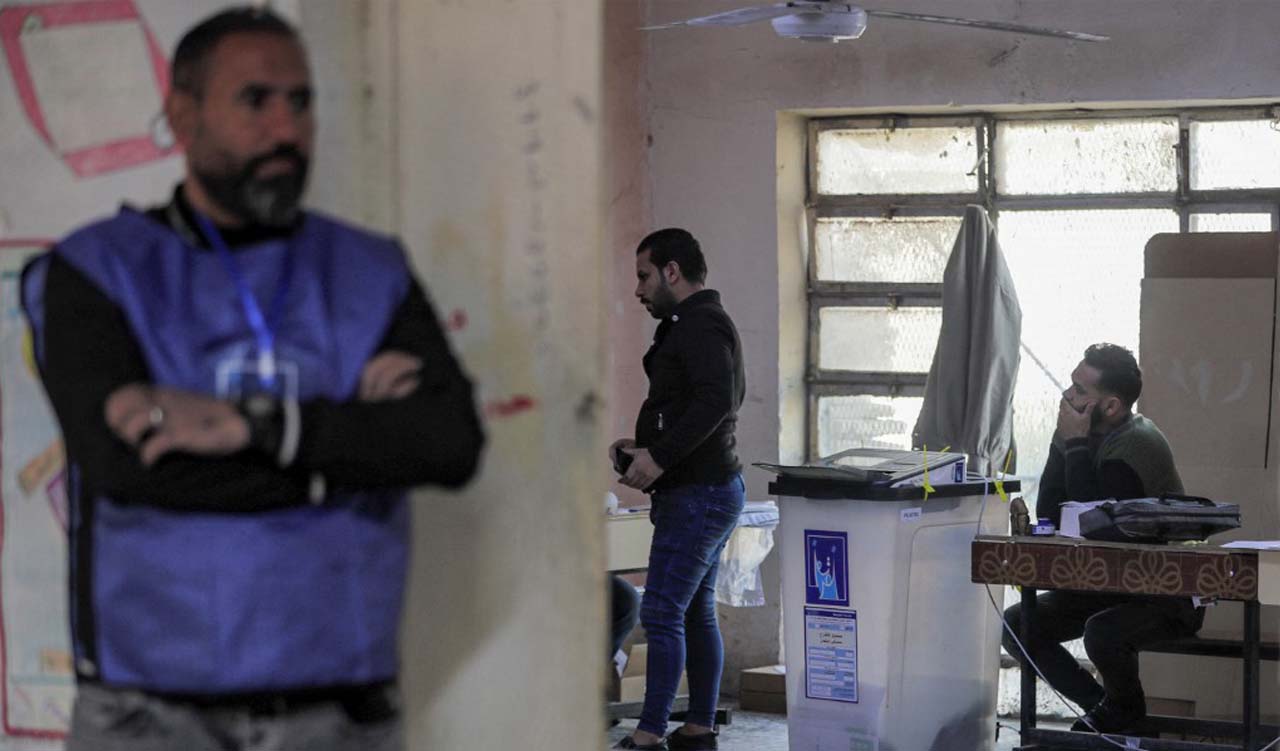 A voter registers before voting in the 2023 Iraqi provincial council elections, the first such vote in a decade, at a polling station in Sadr City in eastern Baghdad, Dec. 18, 2023. (Photo: Ahmad Al-Rubaye/AFP)