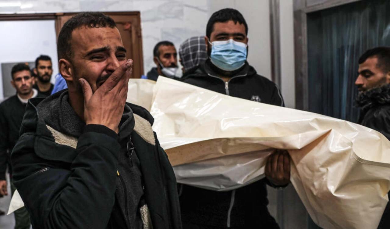 Mourners move the body of Palestinian, killed during an Israeli strike, from the EU hospital in Khan Yunis, southern Gaza (Photo: Said Khatib/AFP)