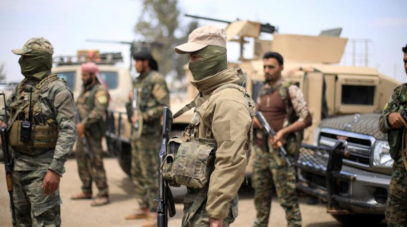 Fighters from the Syrian Democratic Forces (SDF) stand guard in Syria's eastern city of Deir al-Zor, May 1, 2018. (Photo: Reuters/Rodi Said)