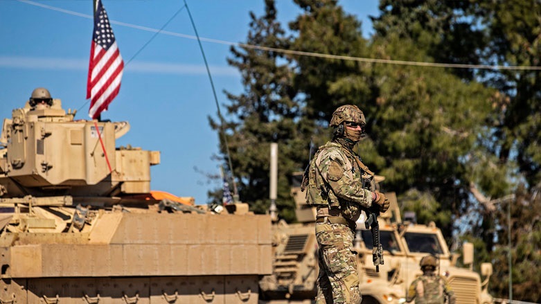 A US soldier stands by a Bradley Fighting Vehicle (BFV) during a patrol in the countryside near al-Malikiyah (Derik) in Syria's northeastern Hasakah province. Feb. 2, 2021. (Photo: Delil Souleiman / AFP)