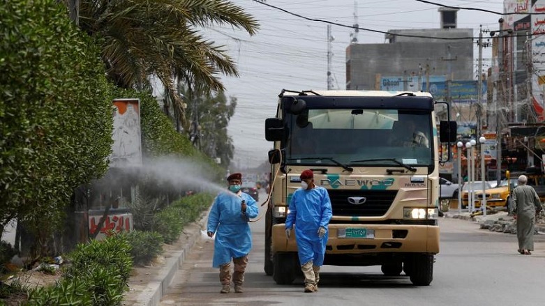 An Iraqi soldier wearing a protective suit sprays disinfectant to sanitize a Baghdad street during a curfew imposed to prevent the spread of the coronavirus, March 31, 2020. (Photo: Reuters/Thaier Al-Sudani)