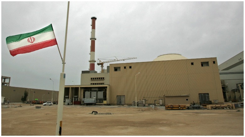 The Iranian flag is flown outside the building housing the reactor of the Bushehr nuclear power plant. (Photo: AFP/Berhouz Mehr)