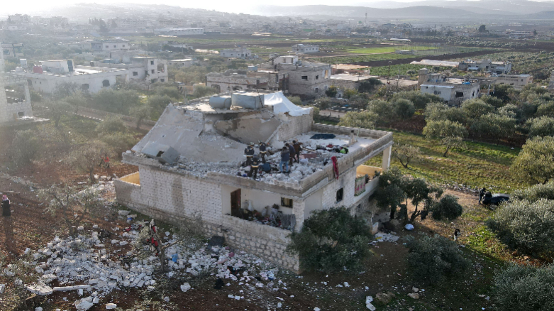 Syrians gather on February 3, 2022 at the scene following an overnight raid by US special operations forces, Feb. 3, 2022. (Photo: Aaref Watad/AFP)