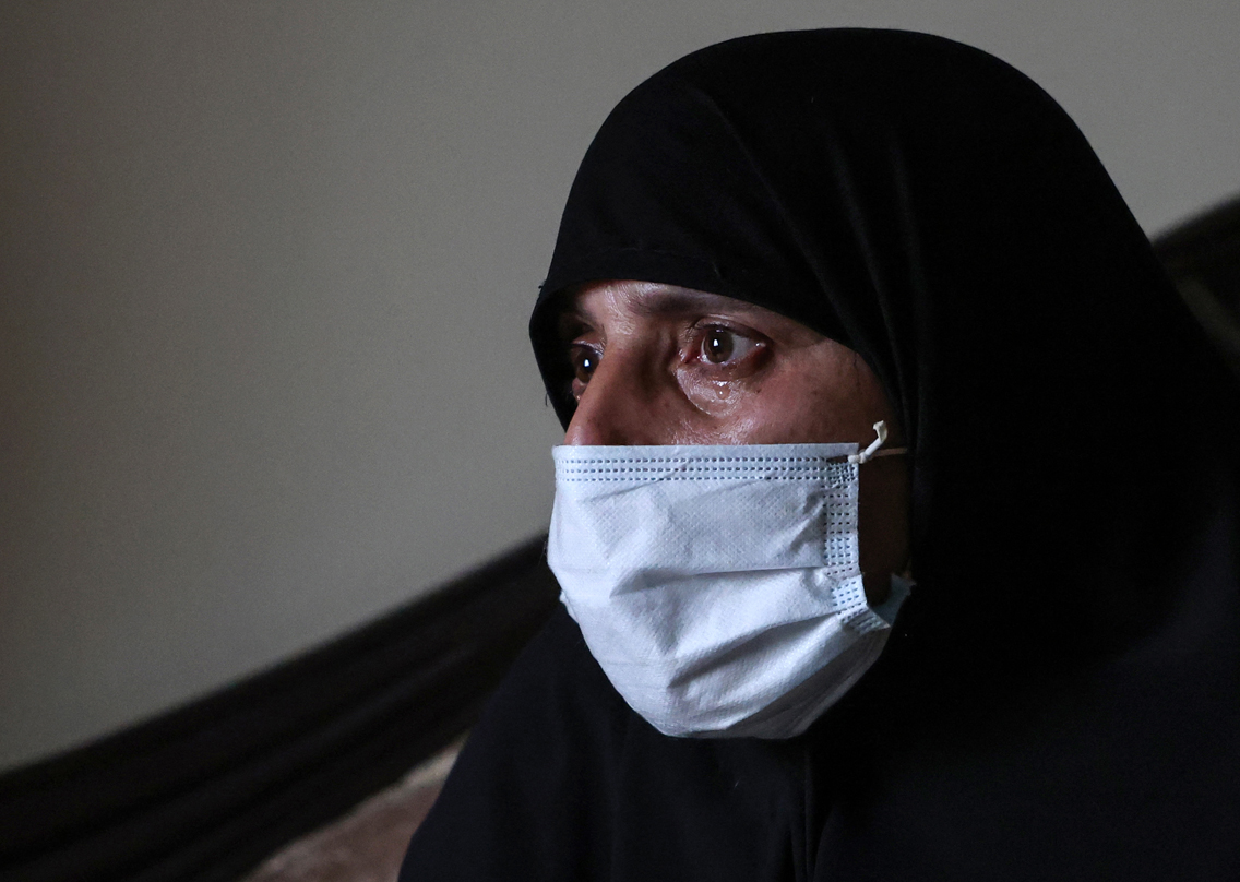 The mother of Omar Seif who disappeared from the northern Lebanese city of Tripoli's neighbourhood of Wadi al-Nahle cries, Jan. 17, 2022. (Photo: Joseph Eid/AFP)