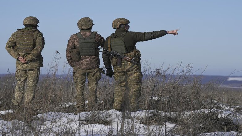 Ukrainian servicemen survey the impact areas from shells that landed close to their positions during the night on a front line outside Popasna, Luhansk region, eastern Ukraine, Monday, Feb. 14, 2022. (Photo: Vadim Ghirda/AP)
