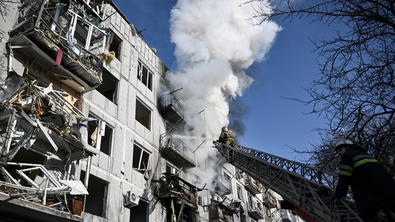 Firefighters work on a fire on a building after bombings on the eastern Ukraine town of Chuguiv, Feb. 24, 2022. (Photo: Aris Messinis/AFP)