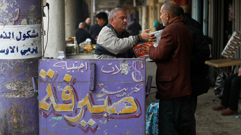 Street money exchangers are seen at al-Kifah stock market in Baghdad, Dec. 27, 2022. (Photo: Ahmad Al-Rubaye/AFP)