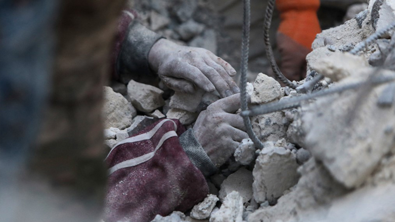 A rescue worker digs to reach a boy under the rubble of a collapsed building in the rebel-held town of Jindayris, Feb. 8, 2023. (Photo: Bakr Al-Kasem/AFP)