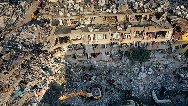 Rescue teams search for people as an excavator removes debris from a destroyed building in Antakya, southeastern Turkey, Friday, Feb. 10, 2023. (Photo: Hussein Malla/ AP)