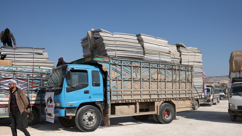 Truck loaded with mattresses distributed by an NGO arrive at a makeshift camp in Afrin in the rebel-held part of Aleppo province on February 16, 2023. (Photo: Omar Haj Kadour/AFP)
