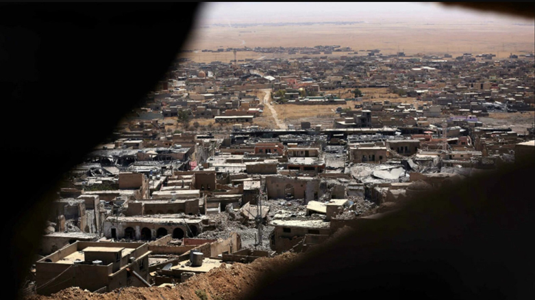 A picture taken on August 17, 2015 shows buildings that were damaged during fighting between Kurdish Peshmerga forces and ISIS militants in the town of Sinjar. (Photo: Safin Hamed/AFP)