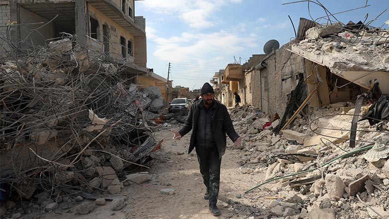 A man walks past collapsed buildings following a devastating earthquake in the town of Jinderis, Aleppo province, Syria, Tuesday, Feb. 14, 2023. (Photo: Ghaith Alsayed/ AP)