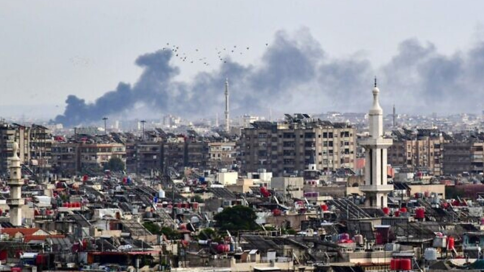 Smoke billows above buildings after an Israeli strike on the outskirts of Damascus on November 22, 2023. (Photo: AFP)