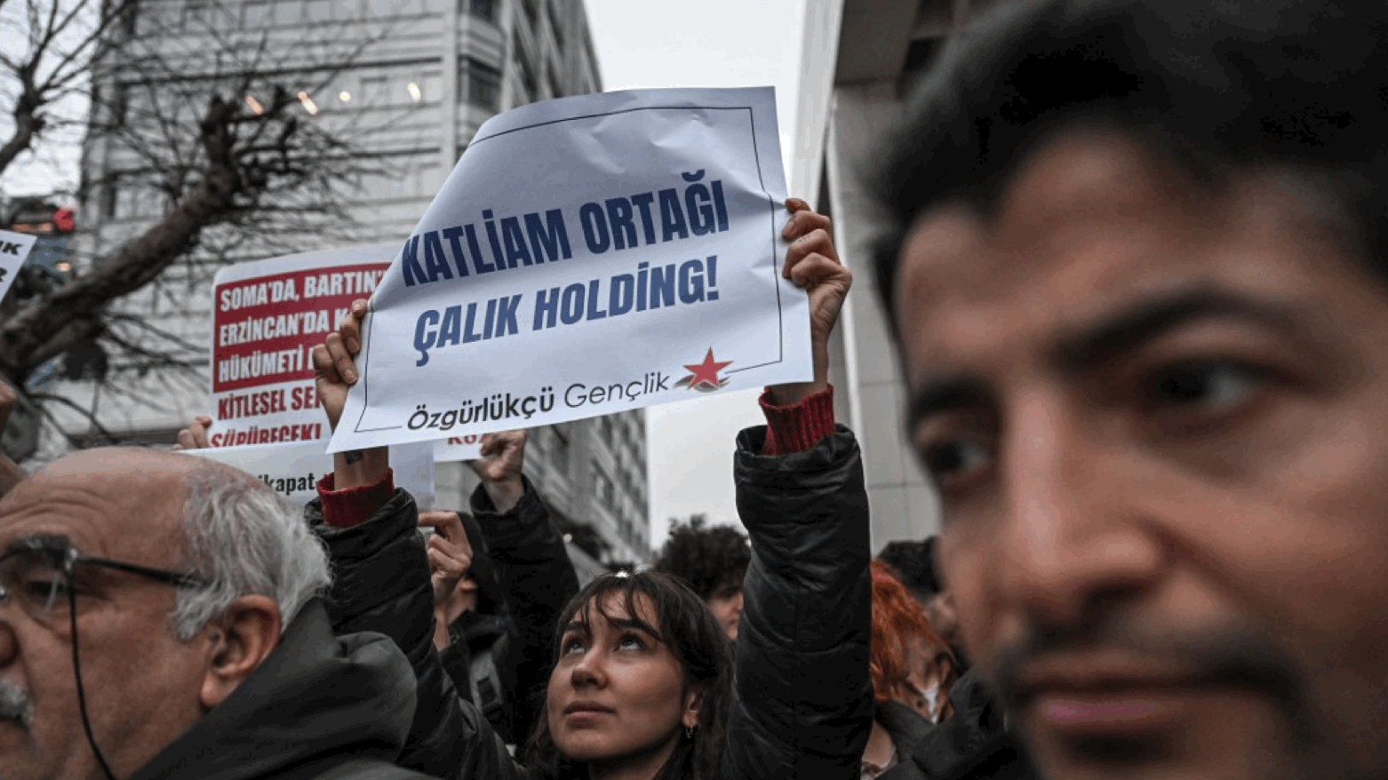 Protesters gather in front of "Calik Holding", in Istanbul on February 14, 2024, following a substantial landslide affecting a vast area surrounding the gold mine in Ilic district of Erzincan (Ozan Kose/AFP)