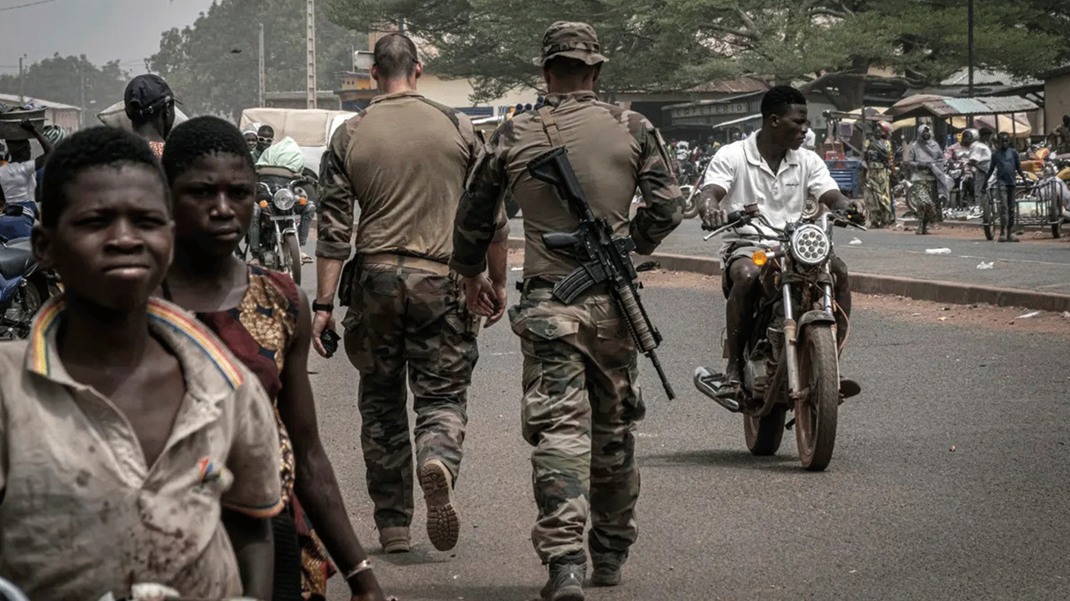 French army military instructors walk on one of the main roads in Tanguietan, northern Benin, March 28, 2022. (Photo: AP)